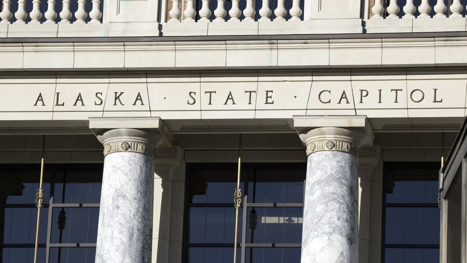 The words Alaska State Capitol carved above marble columns at the Capitol entrance in Juneau