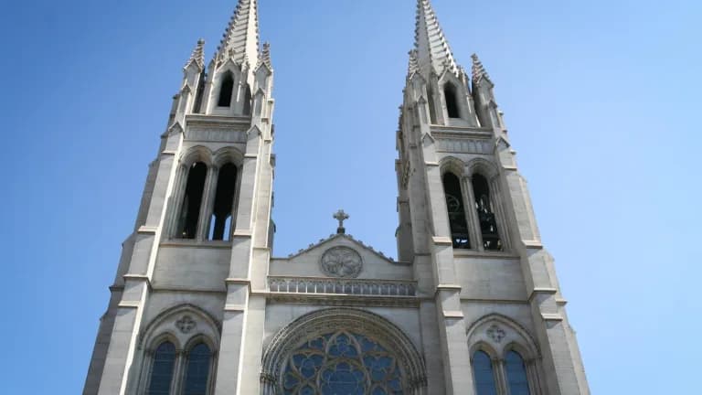 Twin Gothic spires of the Cathedral Basilica of the Immaculate Conception in Denver against a blue sky