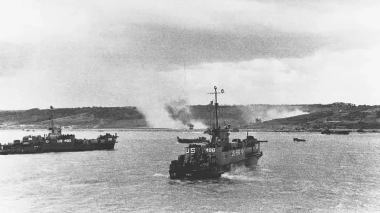 U.S. Navy landing craft LCI(L)-490 and LCI(L)-496 approach Omaha Beach as smoke rises from the shore, June 1944