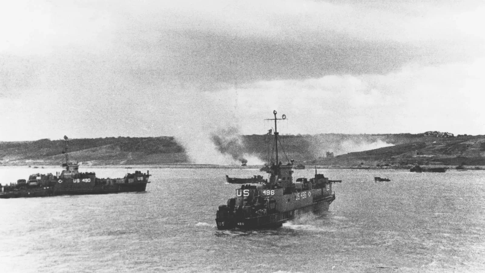 U.S. Navy landing craft LCI(L)-490 and LCI(L)-496 approach Omaha Beach as smoke rises from the shore, June 1944