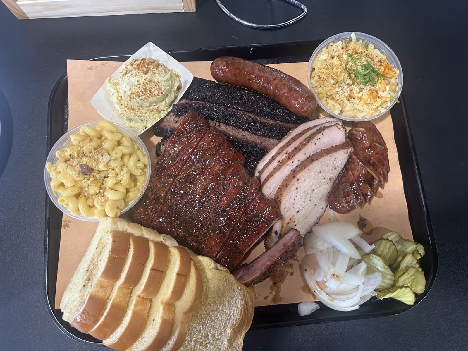 GW’s BBQ tray with brisket, ribs, sausage, turkey, and sides in San Juan, Texas