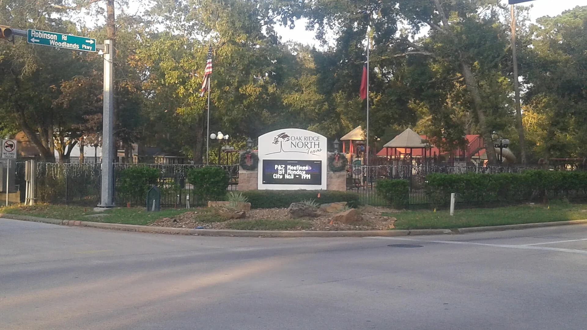 Oak Ridge North, Texas city sign at Robinson Road and Woodlands Parkway, in front of a park