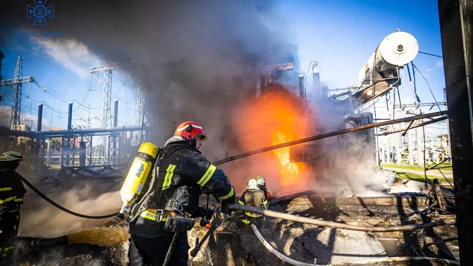 Firefighters battle a blaze at a combined heat and power plant in Kyiv after a Russian missile strike