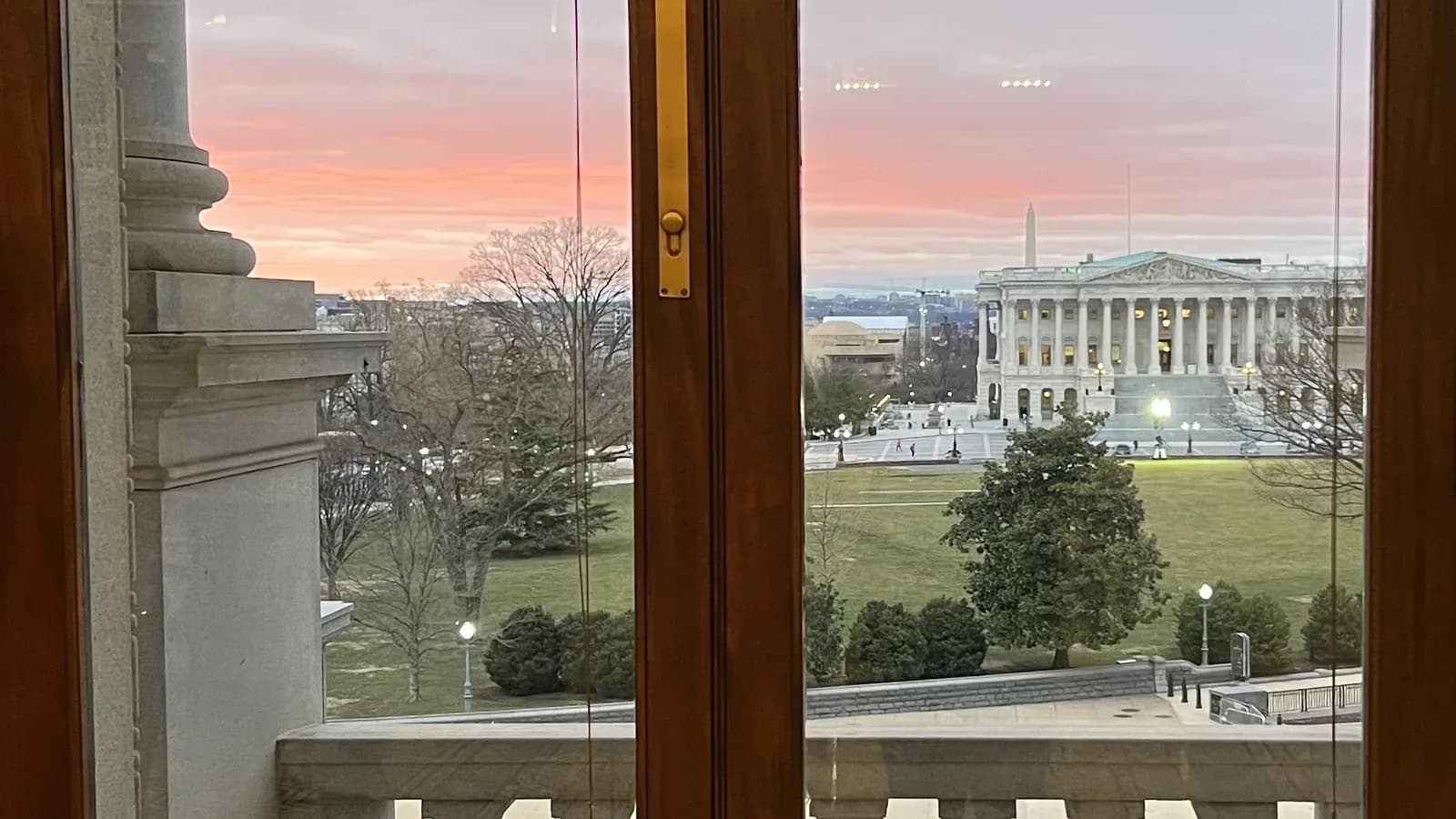The U.S. Supreme Court building seen from the Library of Congress, with the Washington Monument in the distance