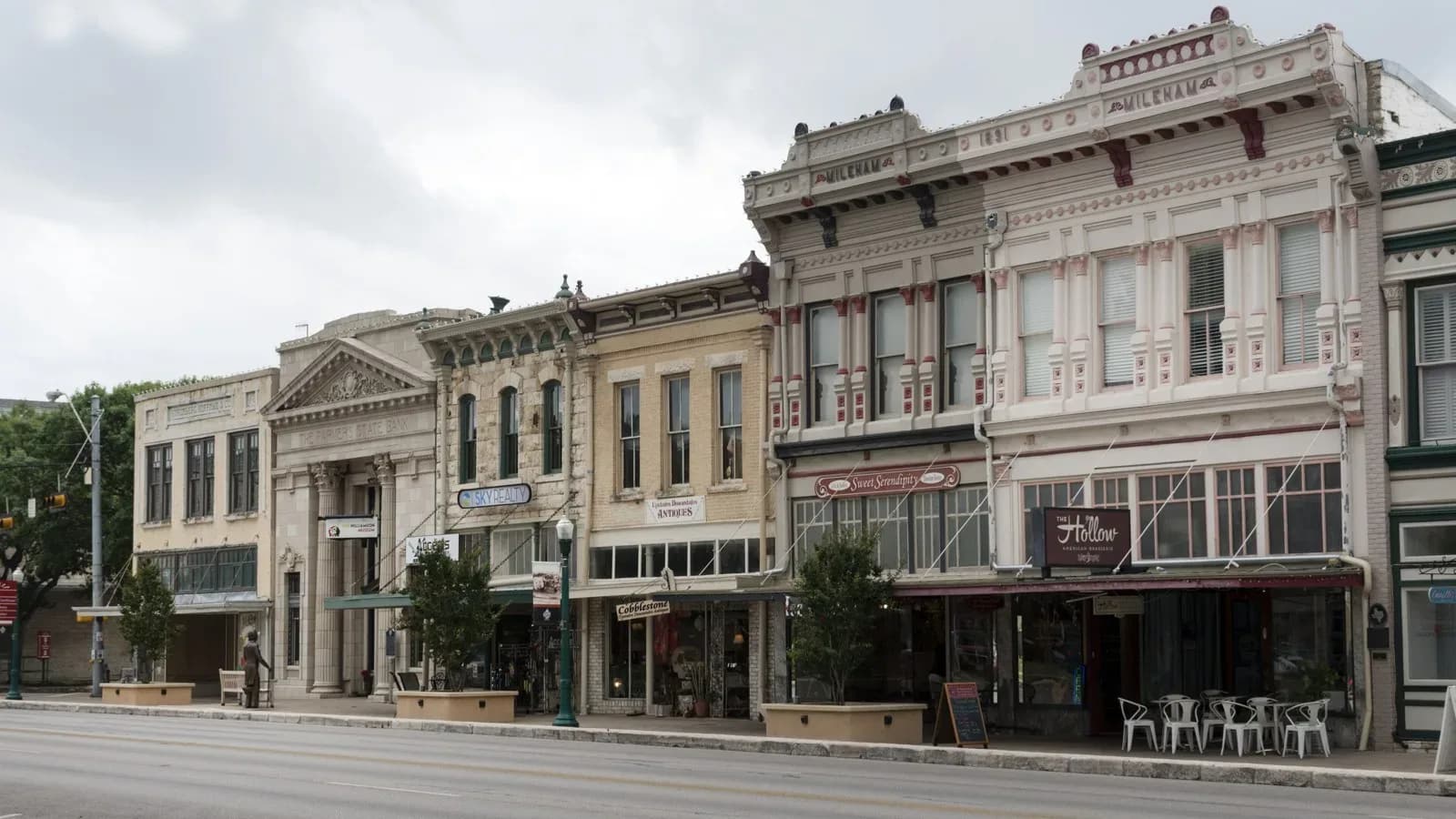 A row of restored two-story Victorian commercial buildings with ornate cornices on the Georgetown courthouse square