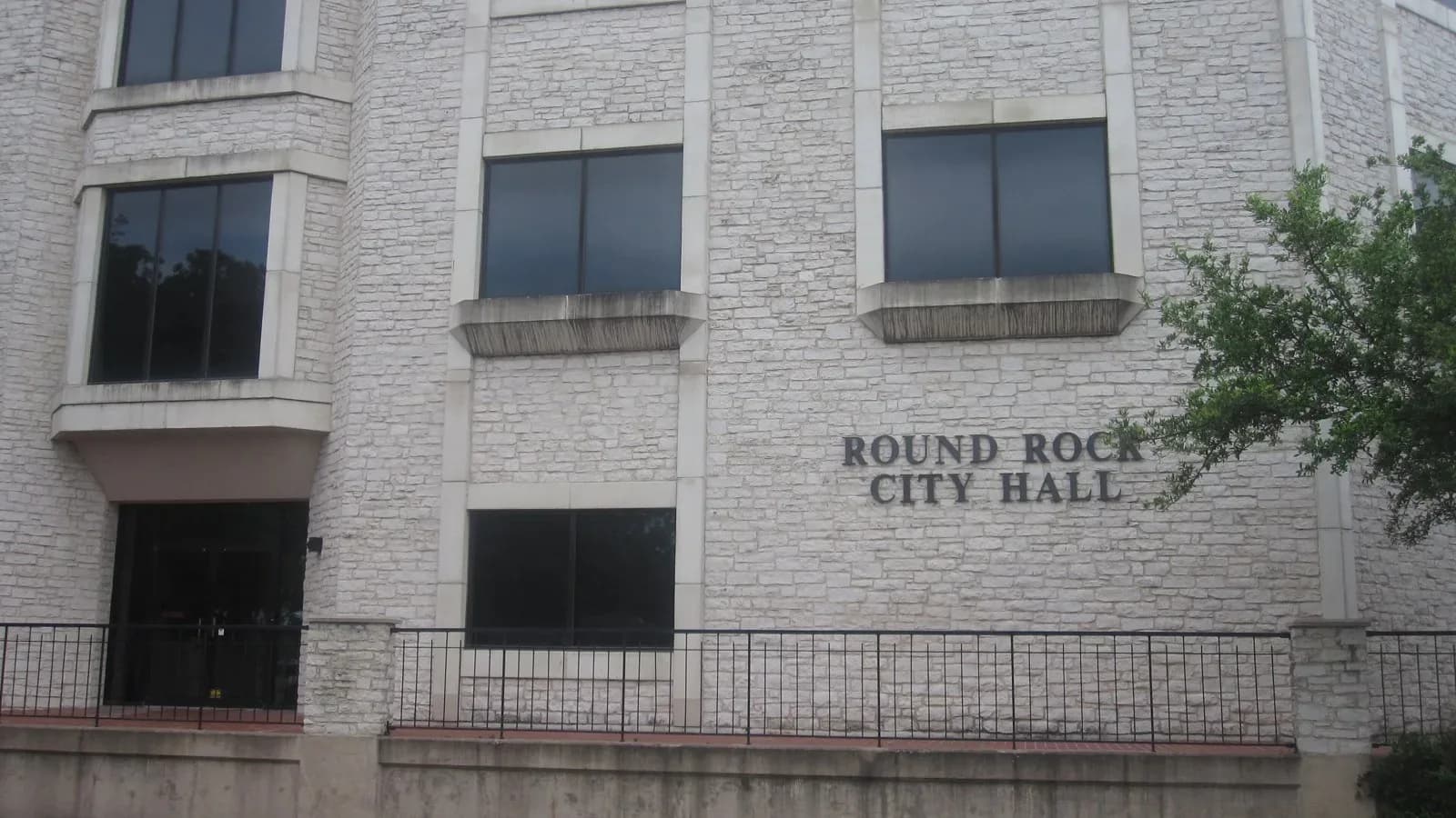 The stone front of Round Rock City Hall with its name lettered on the wall