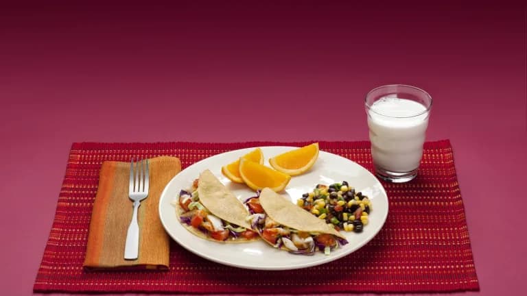 A dinner plate with vegetables, fruit, protein and grains