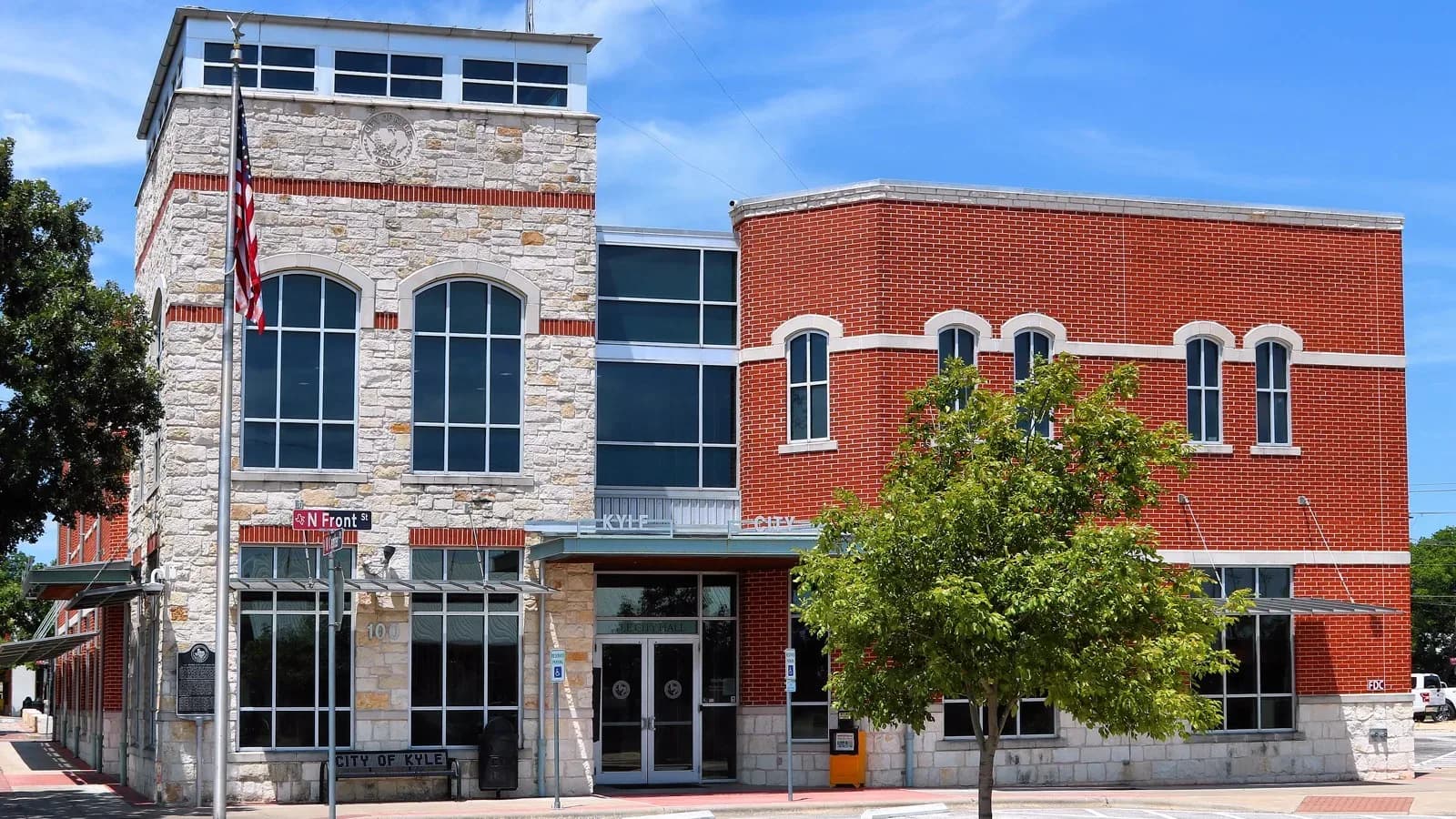 Kyle City Hall, a modern building with a tower entrance, under a clear sky