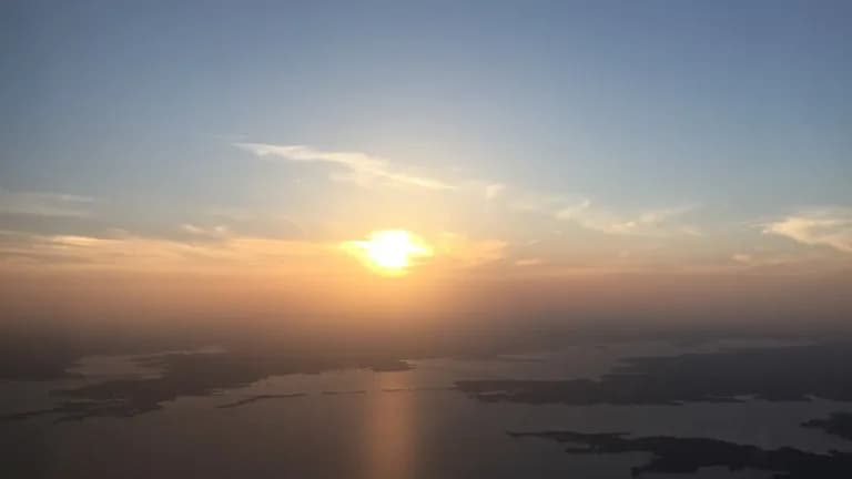 Aerial view of Lewisville Lake at sunset with shoreline neighborhoods