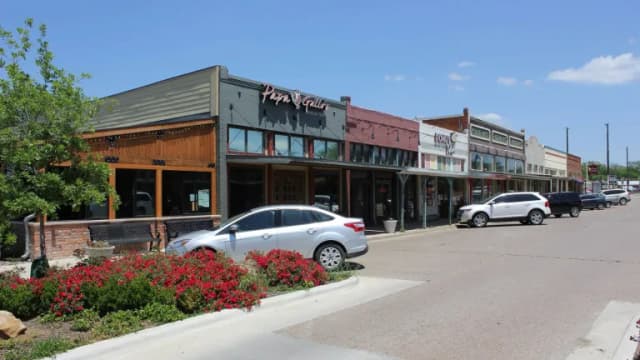 Brick and wood storefronts along a street in downtown Celina, Texas