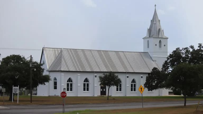 The white Immaculate Conception Catholic Church in Panna Maria, Texas, with its tall steeple