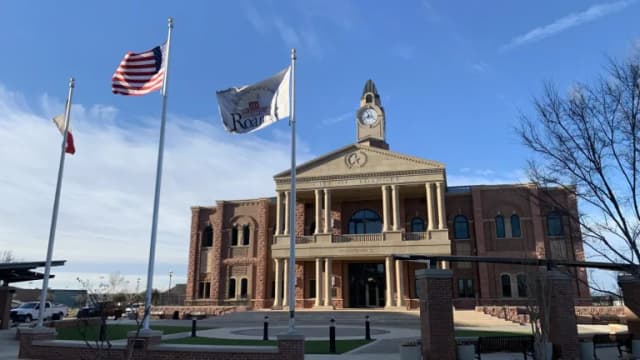 Roanoke City Hall with its clock tower and flags flying in front