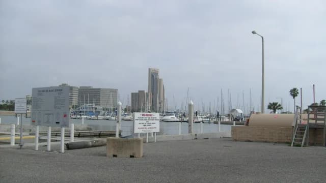 Boats in the harbor along the Corpus Christi bayfront with downtown buildings behind