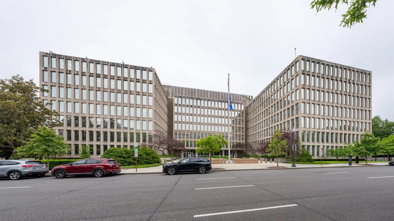 The Theodore Roosevelt Federal Building in Washington, headquarters of the U.S. Office of Personnel Management, with a flagpole out front