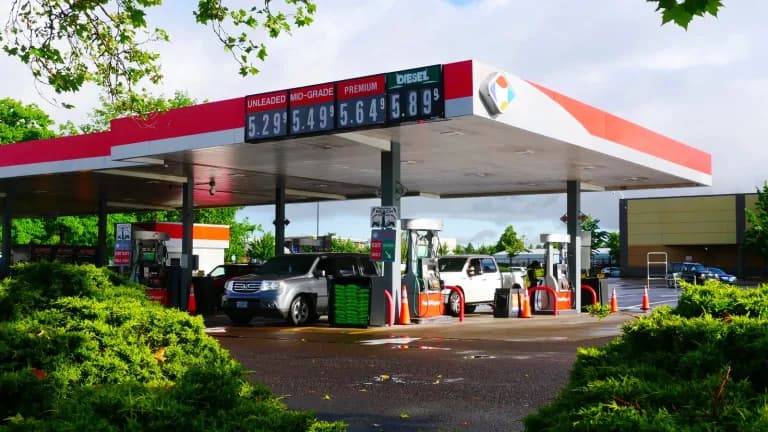 Gas station canopy with a price sign showing unleaded, mid-grade, premium and diesel prices