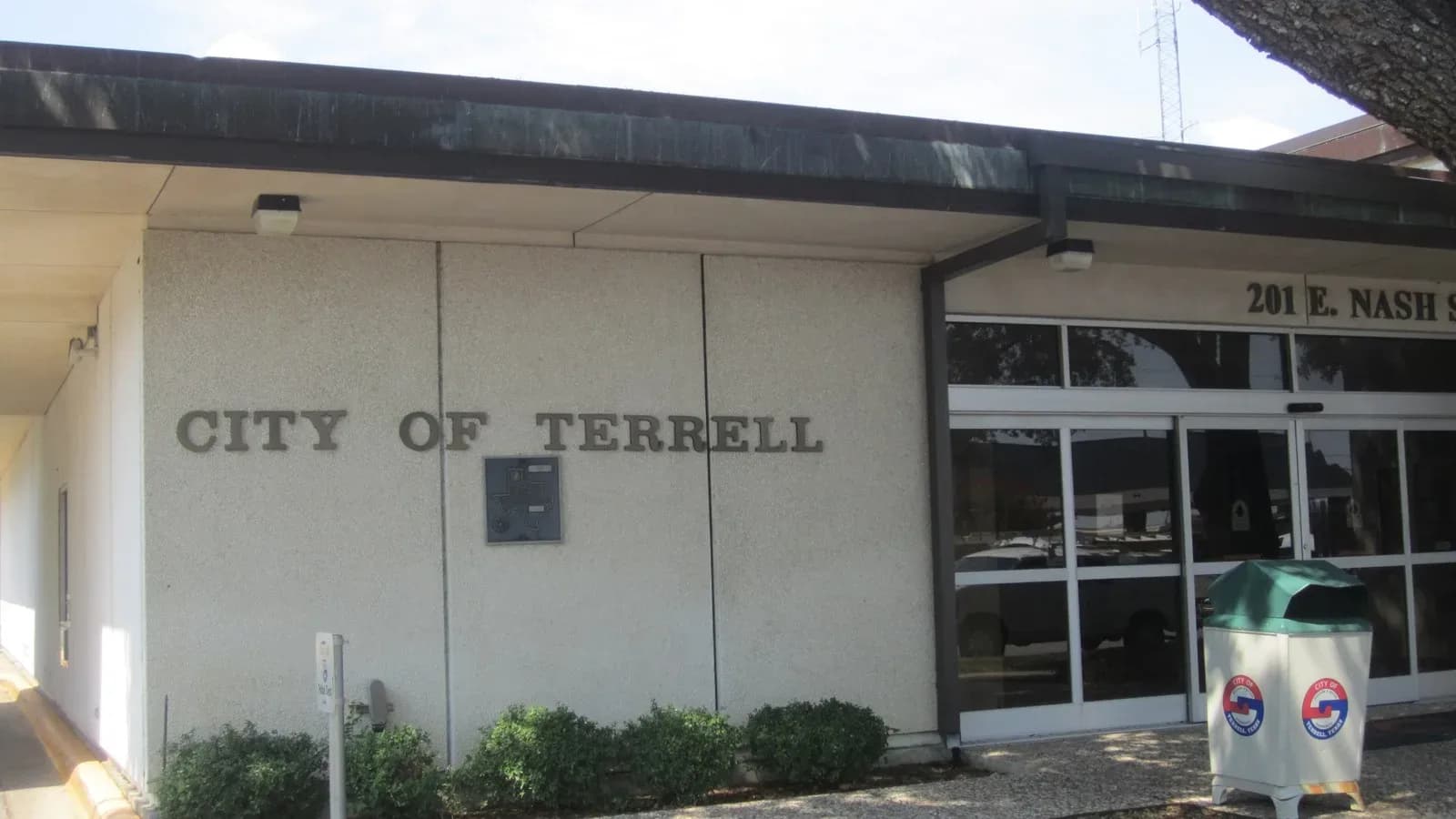 The front of Terrell City Hall, a low tan building with City of Terrell lettering and glass doors at 201 E. Nash St.