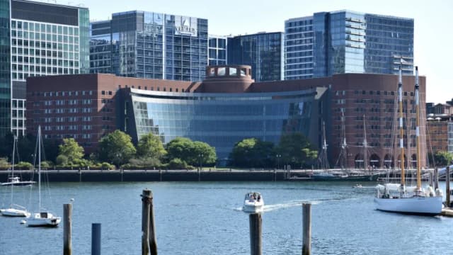 The John Joseph Moakley U.S. Courthouse on the Boston waterfront, with sailboats in the harbor