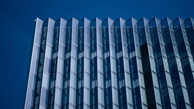 Glass facade of the First Street U.S. Courthouse against a blue sky in downtown Los Angeles