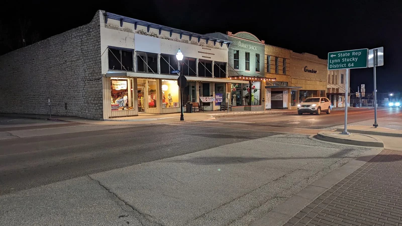 Storefronts on the courthouse square in downtown Decatur, lit at night