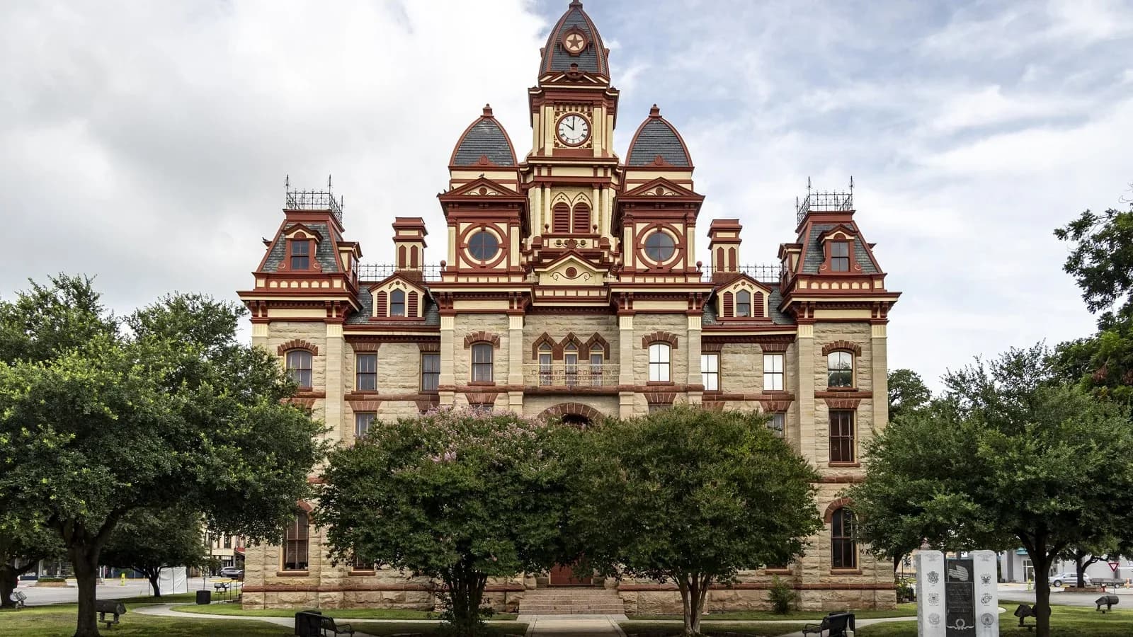 The ornate stone and red-trimmed Caldwell County Courthouse in Lockhart with a central clock tower