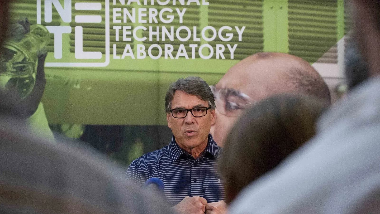 Rick Perry speaks in front of a National Energy Technology Laboratory sign