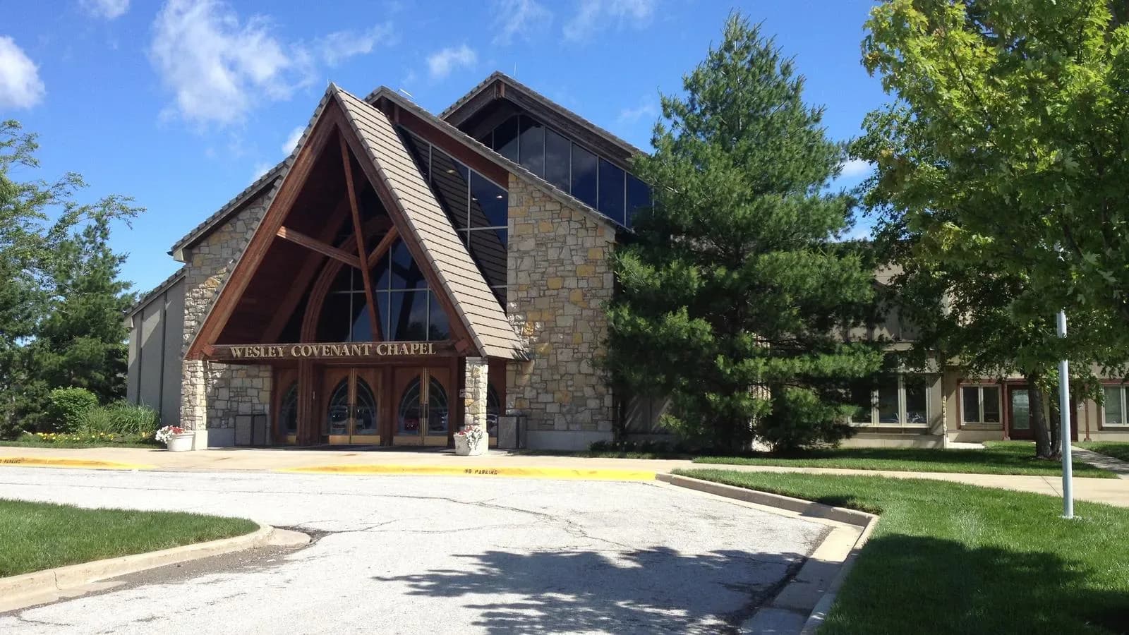 Exterior of Wesley Covenant Chapel, a stone and timber A-frame building at the Church of the Resurrection in Kansas