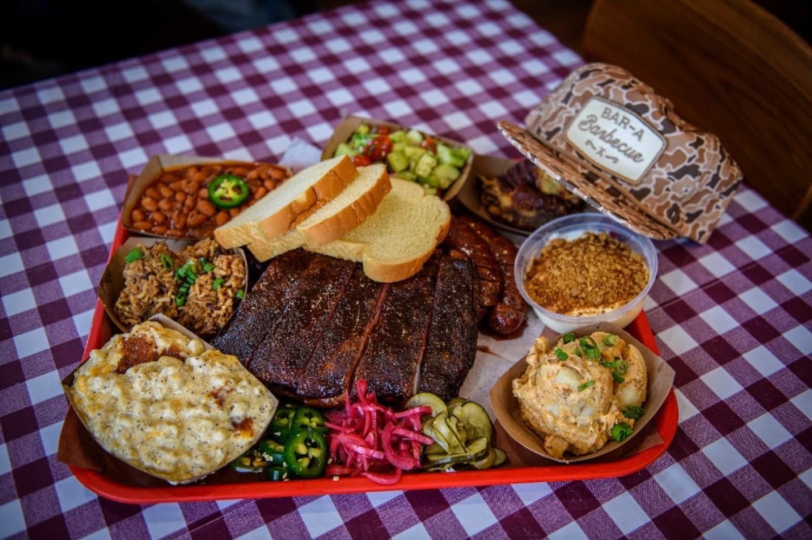 Bar-A-BBQ tray with ribs, sausage, sides, and dessert in Montgomery, Texas