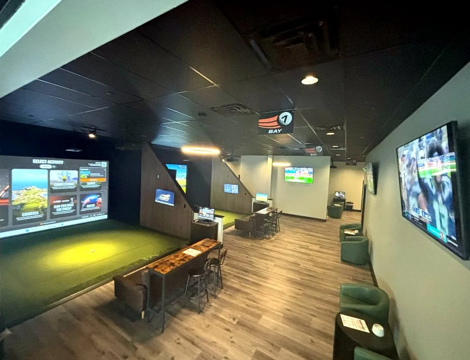 Flight Indoor Golf lounge with simulator bays and seating in Hockessin