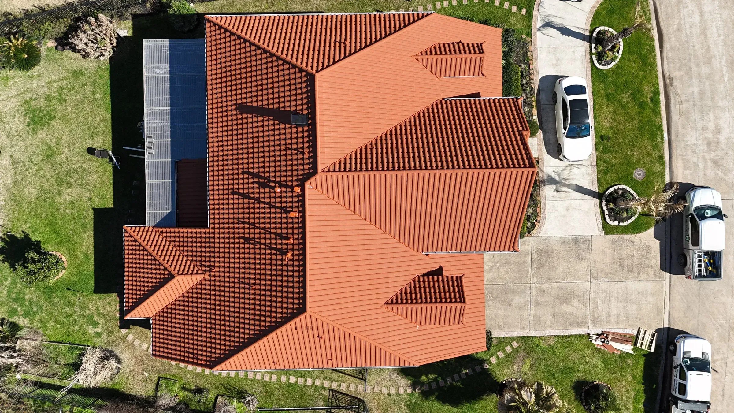 Aerial view of a stone-coated steel roof with a tile profile on a single-story house