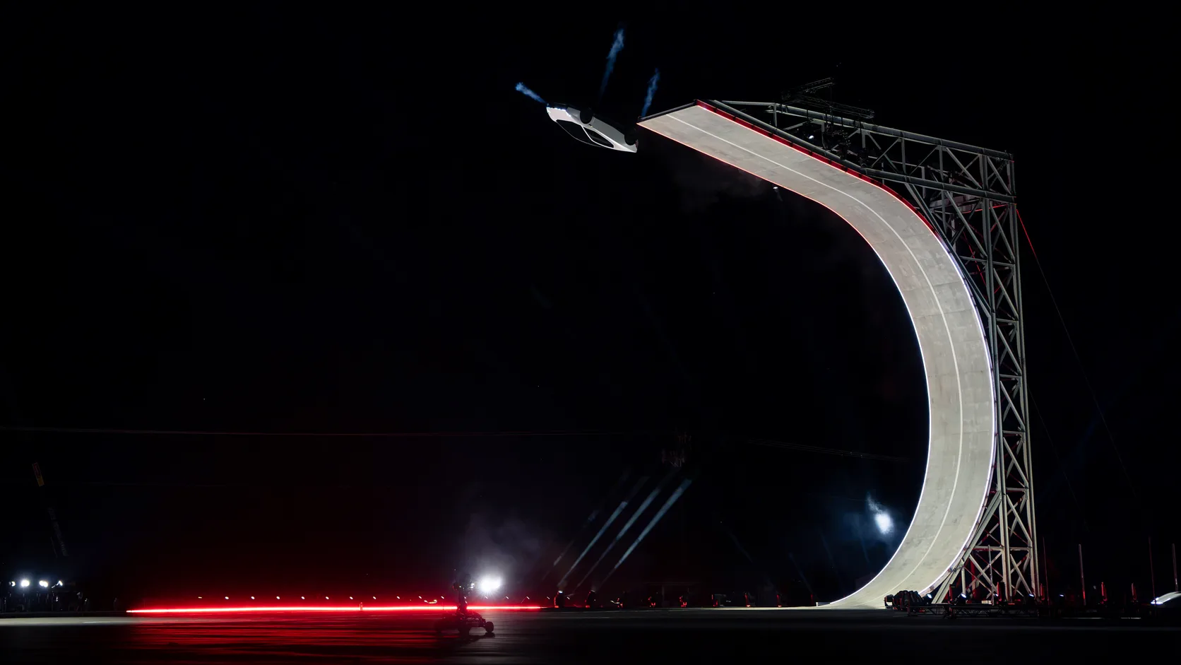The Roadster climbs the demonstration's curved ramp before the suction system holds the car against the surface at an extreme angle. Courtesy of Tesla, Inc.
