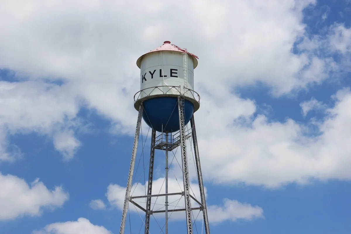 White Kyle water tower against a blue sky