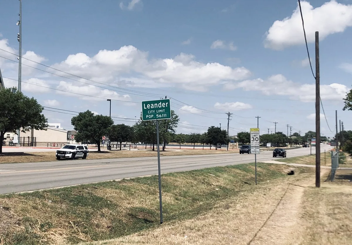 Leander city limit sign along a roadside in Leander, Texas