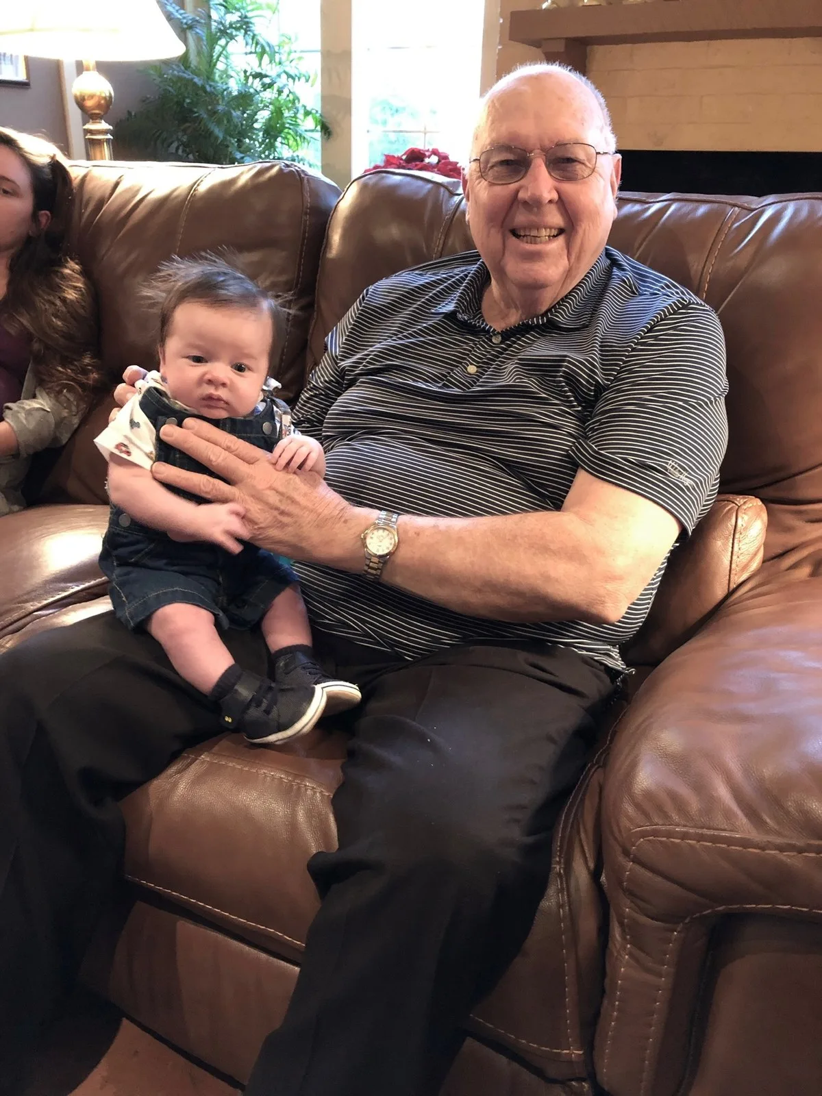 Gerald Mounce holding one of his great-grandchildren