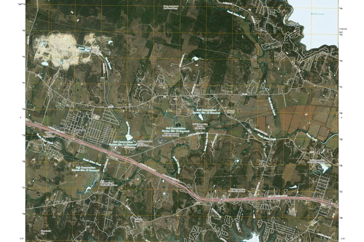 A U.S. Geological Survey satellite topographic map showing Nolanville's street grid beside a divided highway, with creeks and the edge of Belton Lake