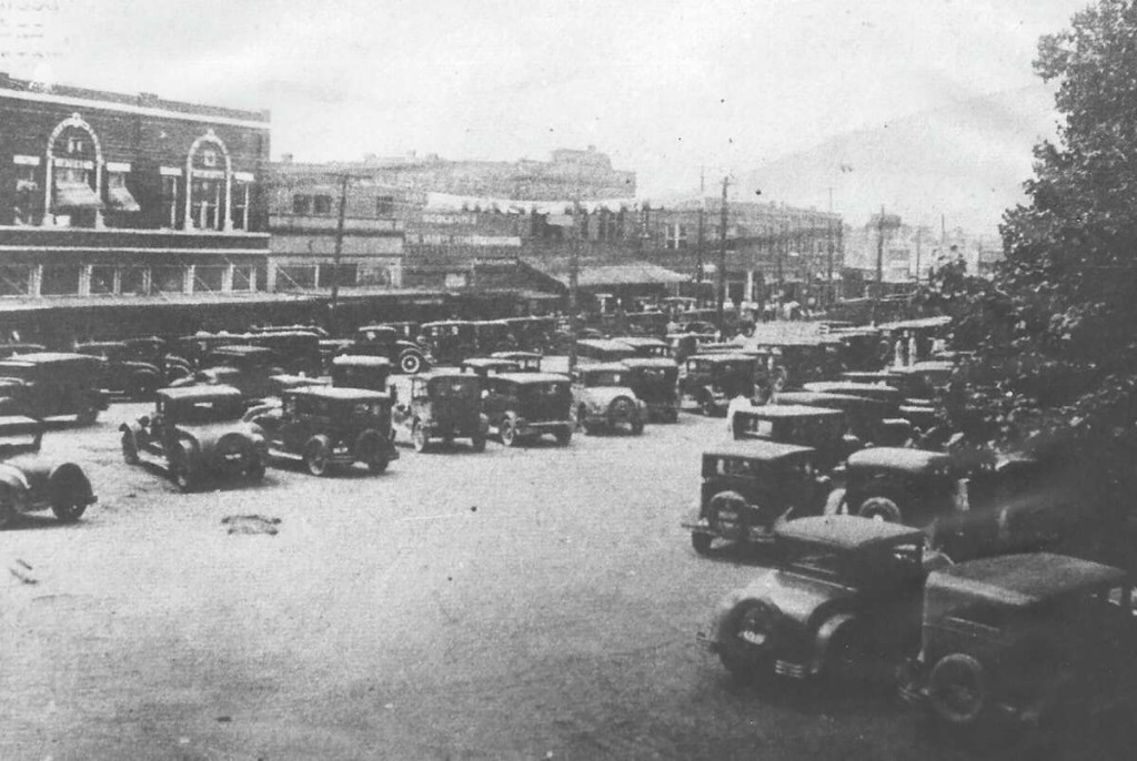 Early automobiles packed into downtown Conroe around the courthouse square