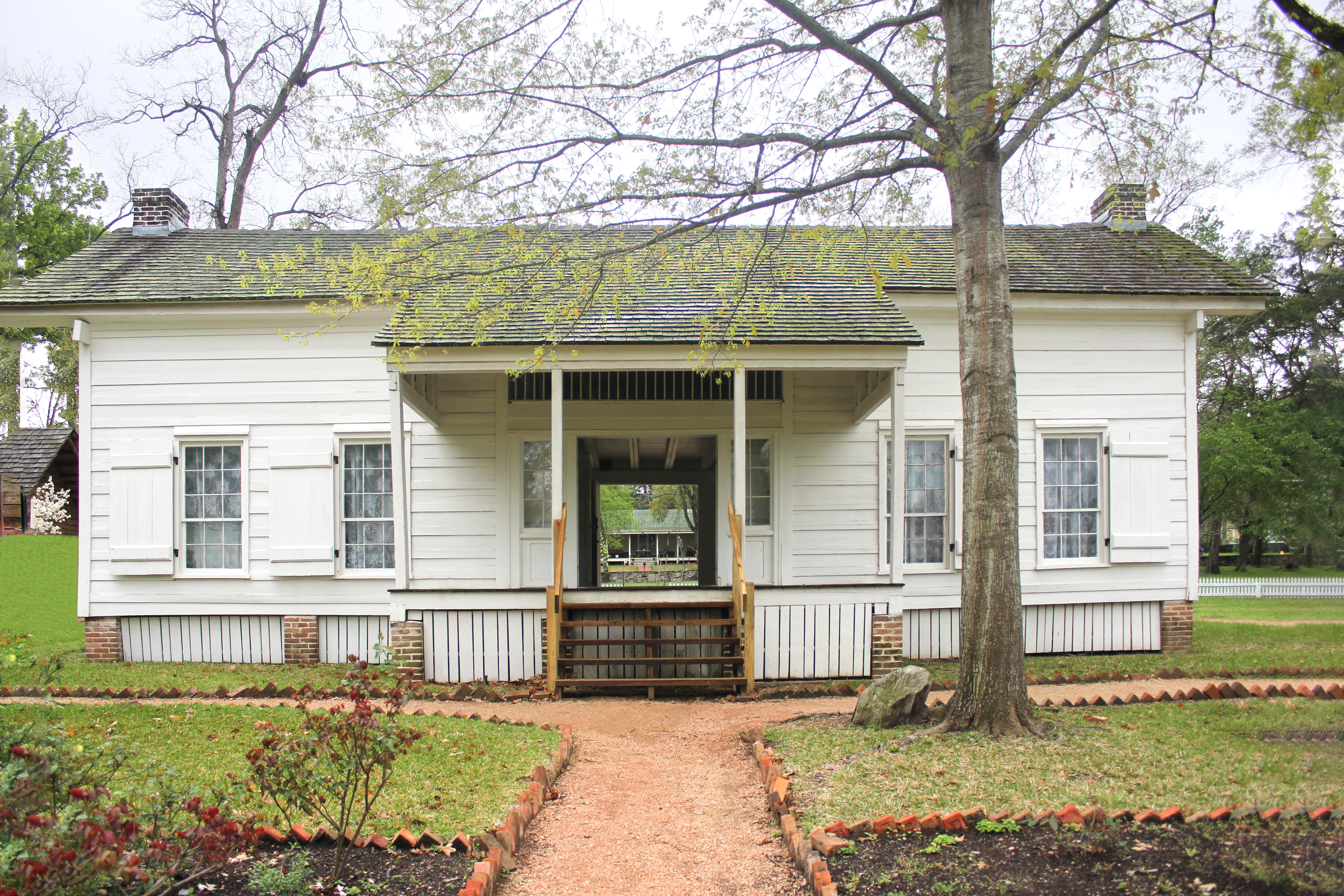 Woodland, Sam Houston’s dogtrot home in Huntsville, Texas, behind a white picket fence