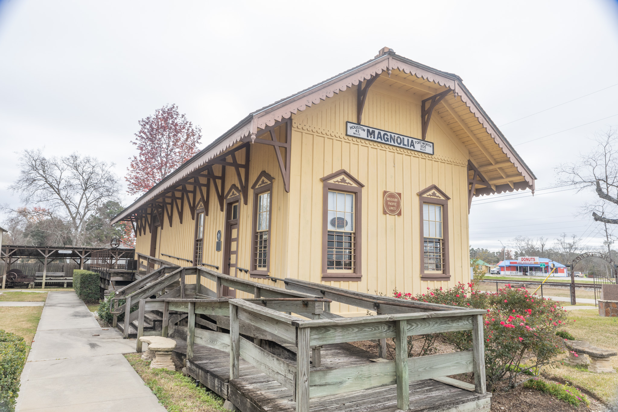 The restored train depot in Magnolia, Texas, beside the railroad tracks