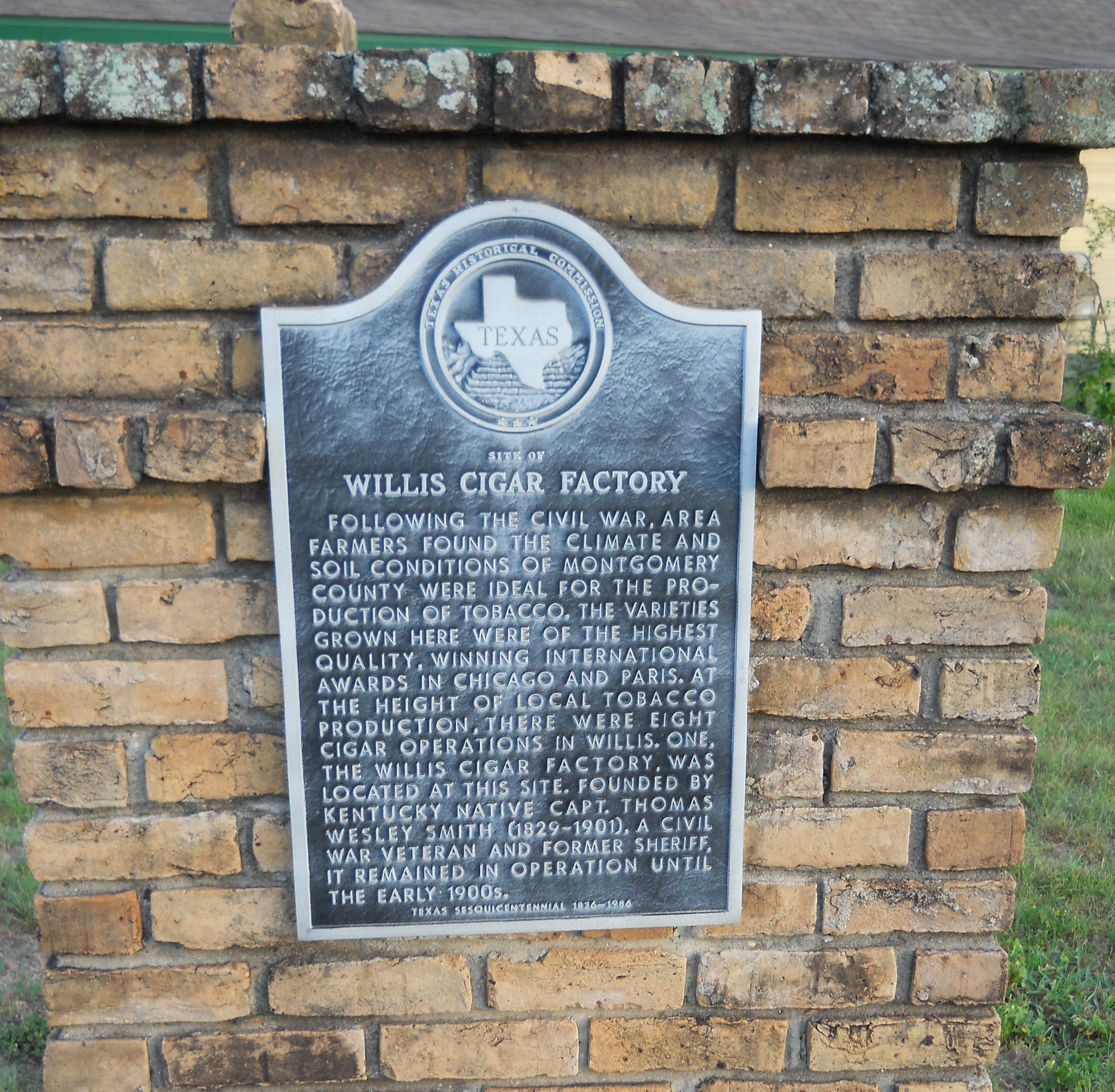Texas historical marker for the site of the Willis Cigar Factory on North Bell Street